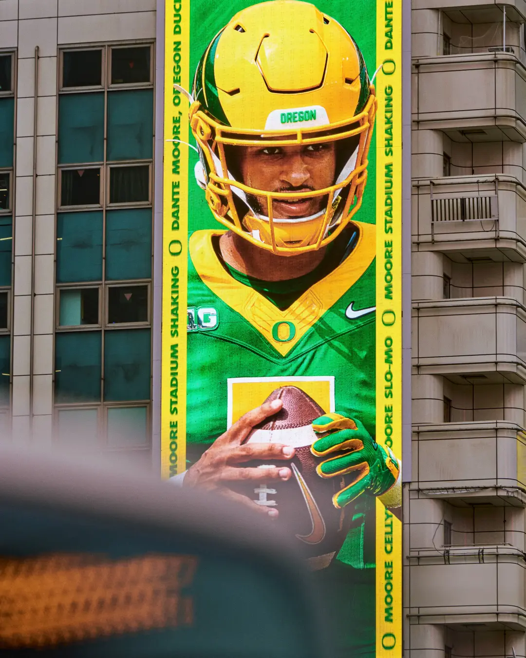 Dante Moore ‘Yes, There’s Moore’ billboard — Stadium Shaking, Tokyo