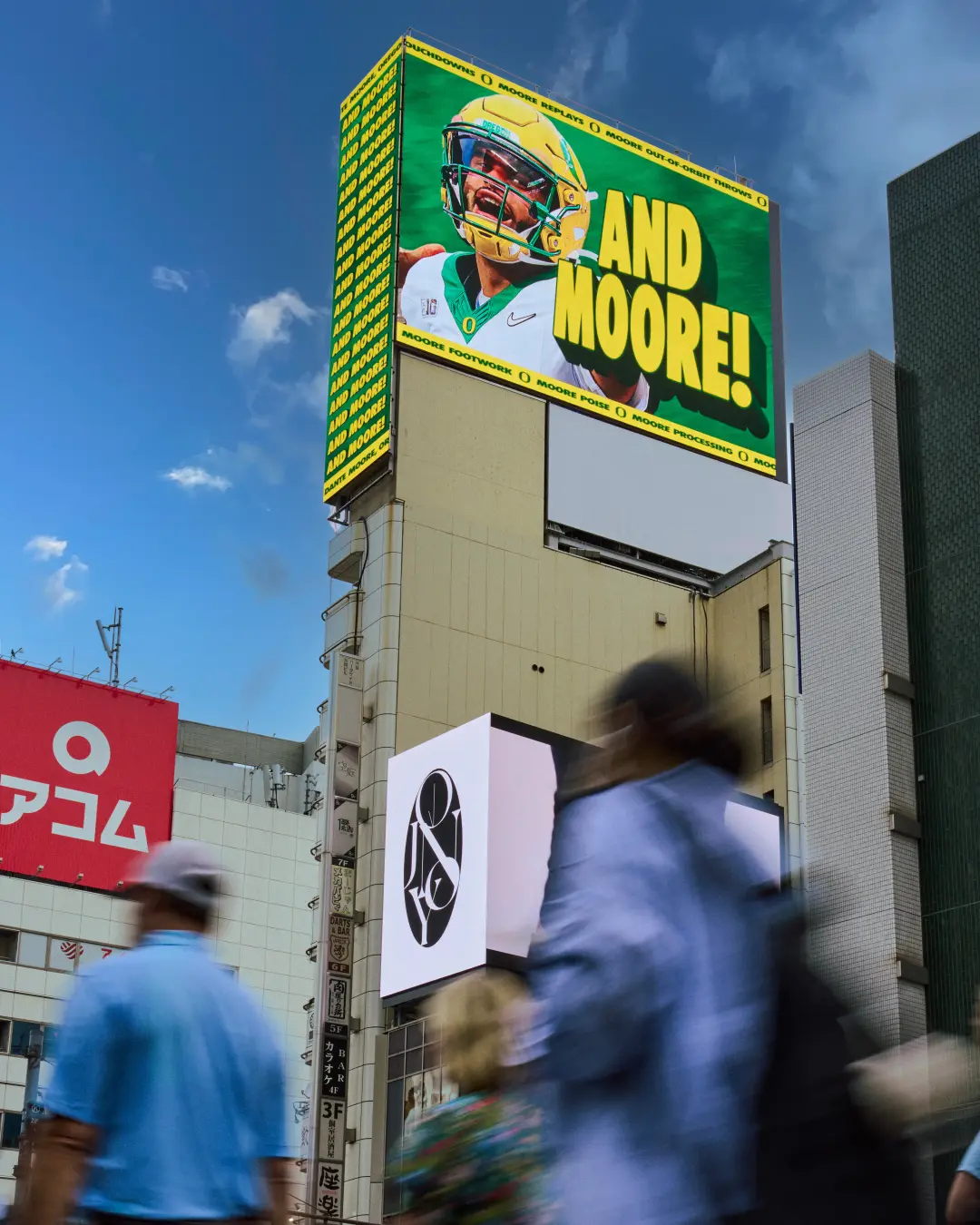 Dante Moore ‘Yes, There’s Moore’ billboard — And Moore, Tokyo
